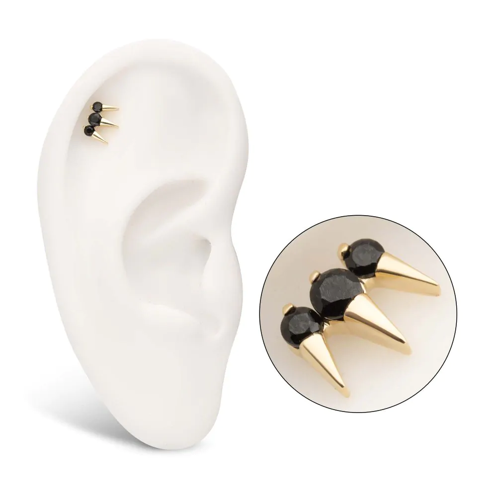 14k gold triple spike stud earring with black Swarovski gems, shown in the helix piercing of a model ear.